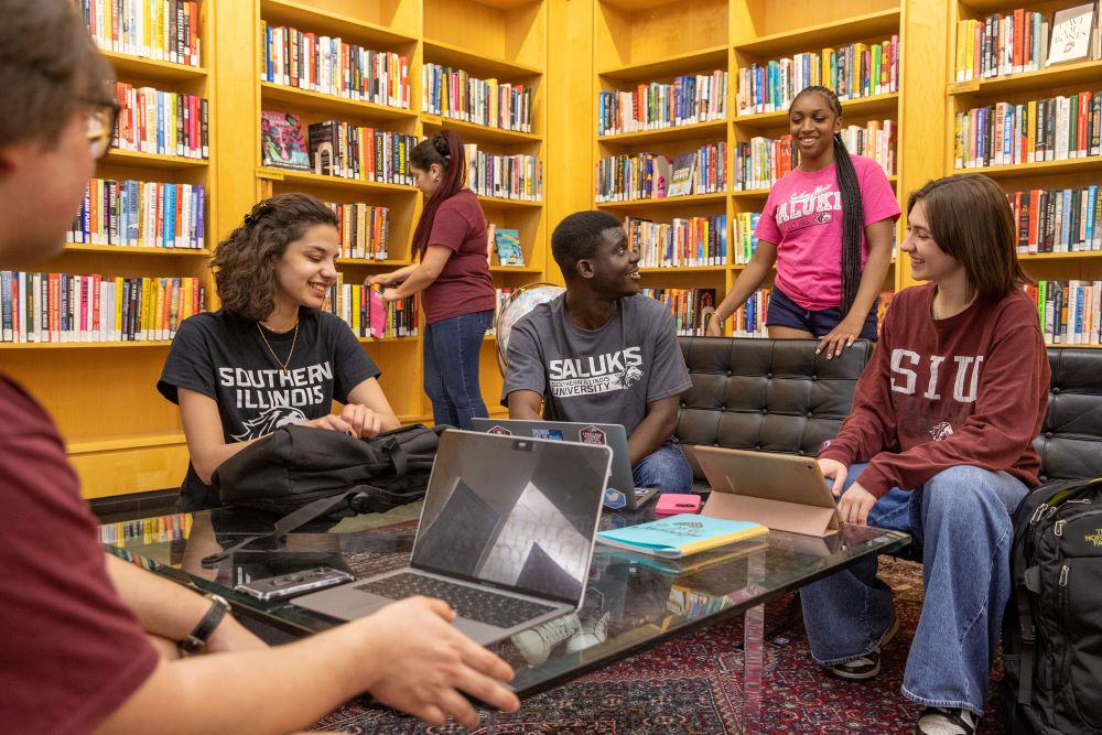 Group of students sitting together in the library.