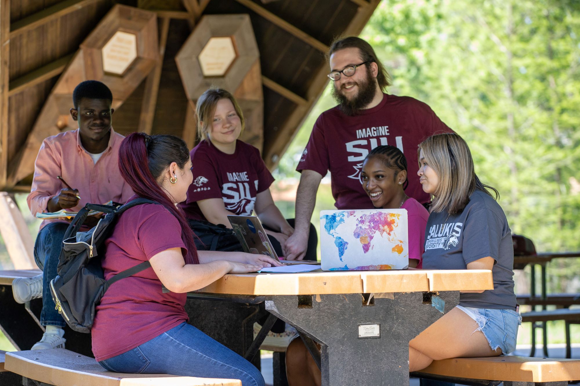 group of students sitting at an outdoor table.
