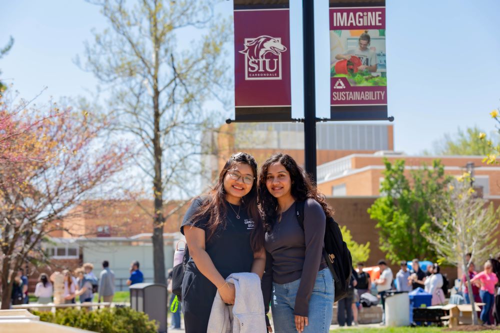 Two students standing outside of the Student Center, north end.