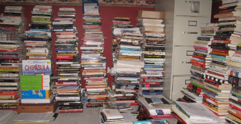 stacks of books lining Chipasula's publishing office
