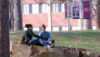 Students sitting on rock